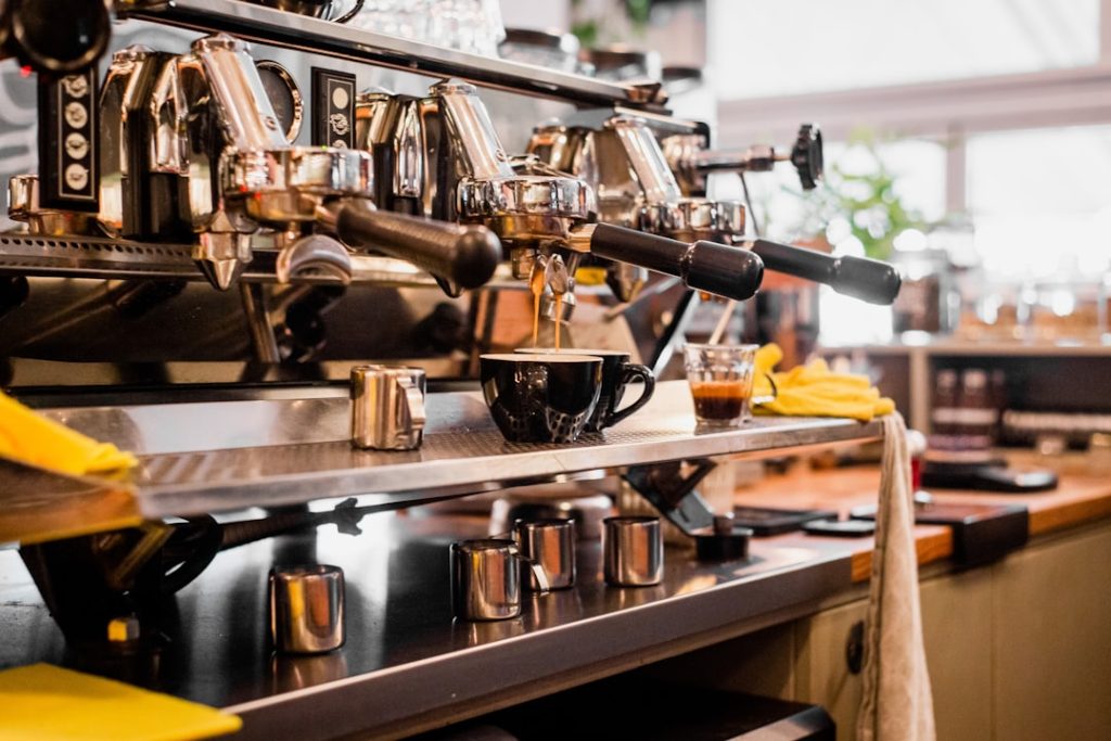 stainless-steel-espresso-machine-on-brown-wooden-table-9v3nl6paxjw